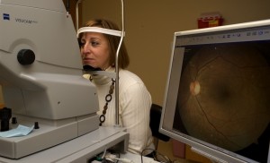 A patient has a digital photograph taken of her eye.